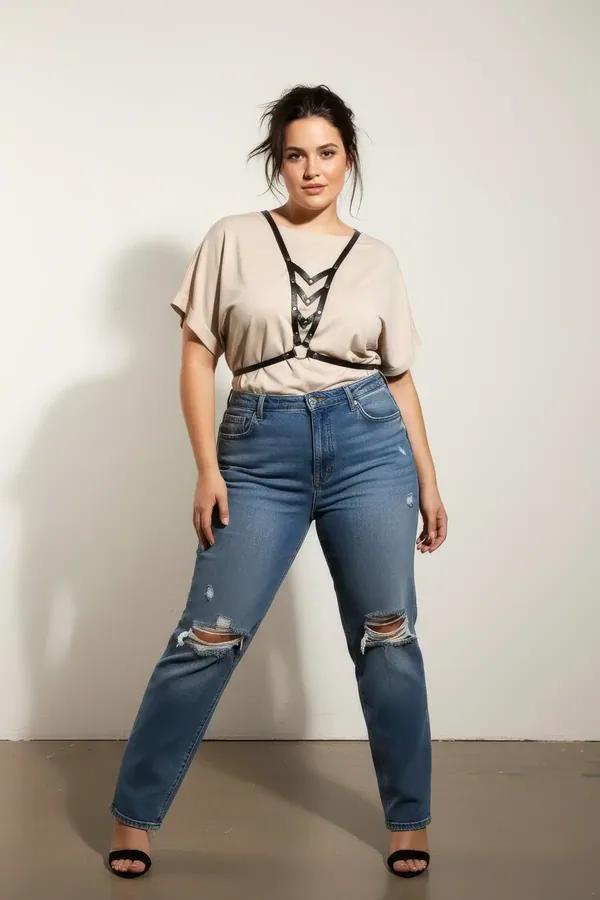 Black faux leather v-neck chest harness with cascading interlinked silver O-rings worn over cream knit top