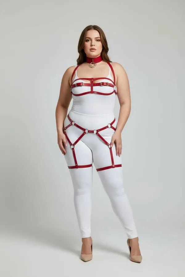 Red faux leather full body harness set with O-ring choker, structured chest frame, and dual thigh garter straps on plus-size