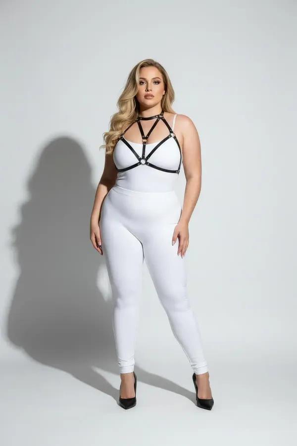 black faux leather strappy body harness with gold O-ring detail and choker collar worn over white bodysuit