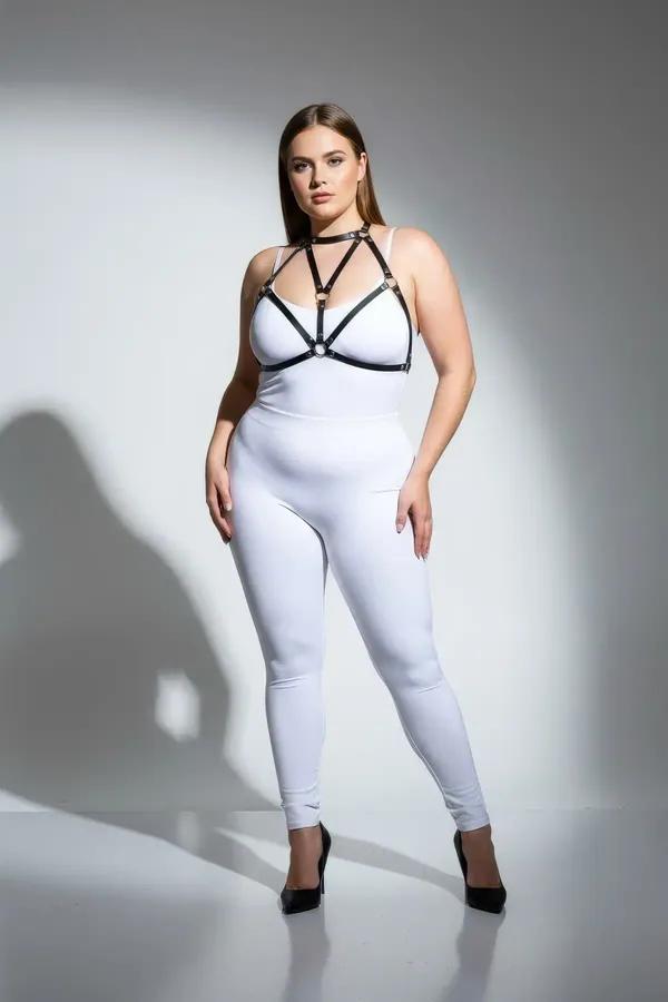 black faux leather strappy body harness with gold O-ring detail and choker collar worn over white bodysuit