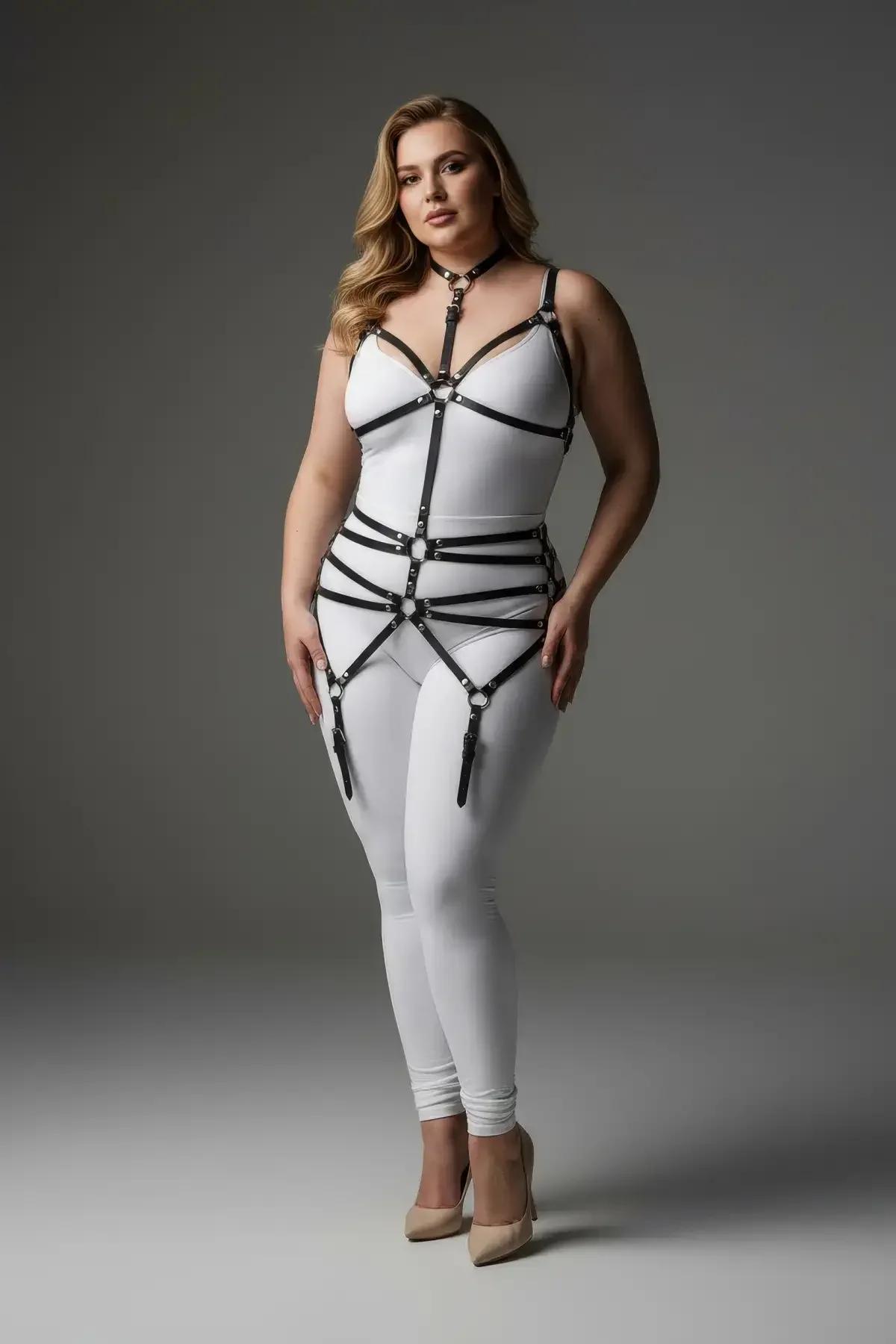 black faux leather full body harness with choker collar, O-ring chest cage, three waist bands, and dangling garter straps on