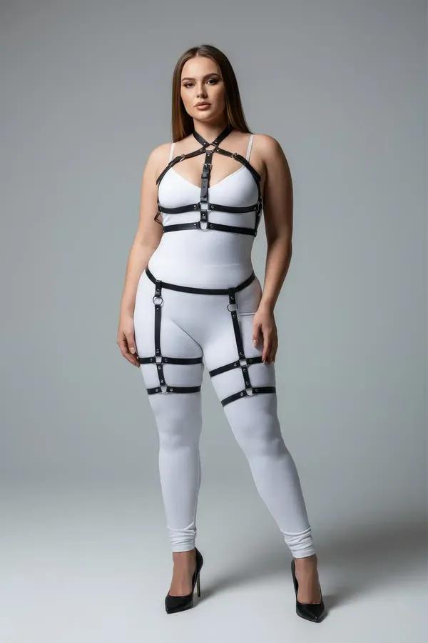 Black faux leather full body harness with garter straps, thigh bands, and silver O-ring hardware on plus-size model