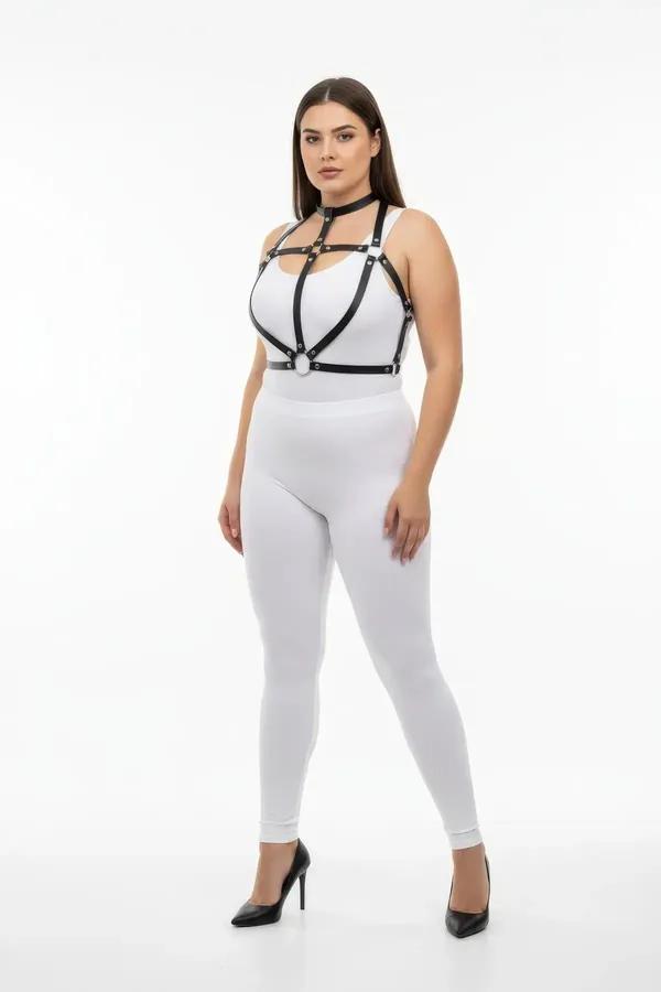 Black faux leather strappy chest harness with silver O-ring detail and integrated choker worn over white outfit