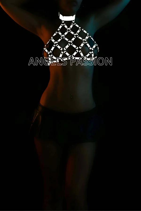 Silver reflective chainmail halter top harness with diamond-lattice metal links glowing under dark club lighting