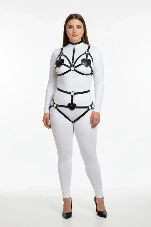 black faux leather harness bra and garter set with heart cut-out panels and silver O-rings on plus-size model