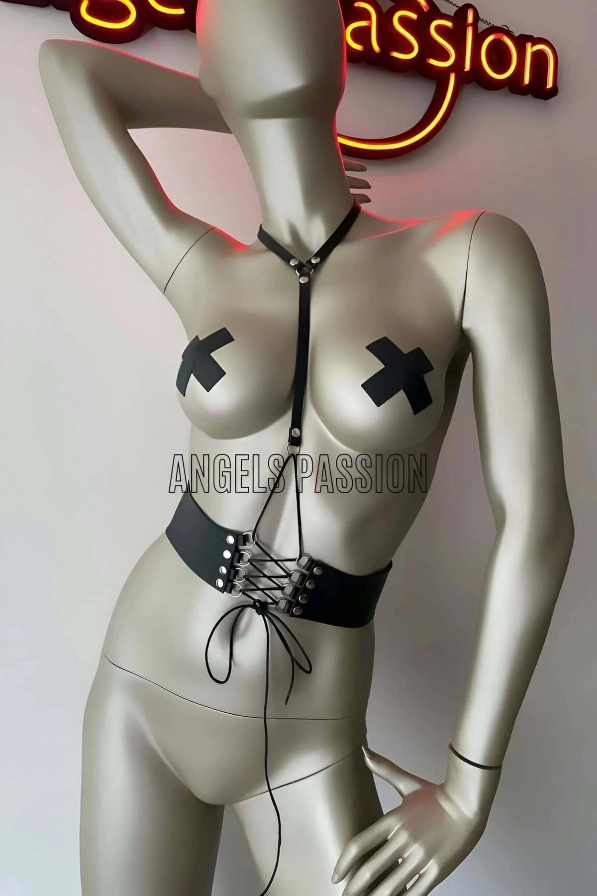 Black vegan leather lace-up corset body harness with silver grommets and adjustable chest strap on mannequin