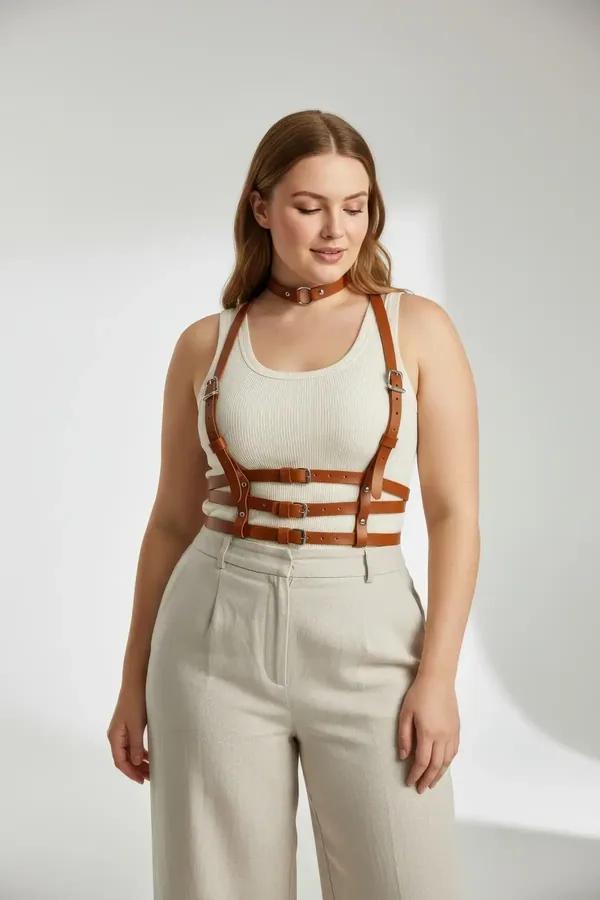 tan vegan leather chest harness with four horizontal straps and matching O-ring choker worn over white tank top, silver buckl