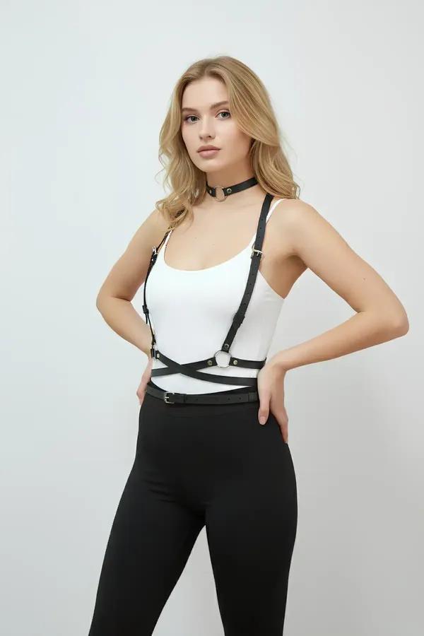 black faux leather body harness with O-ring choker set, gold-tone hardware, cross-strap waist cage worn over white tank