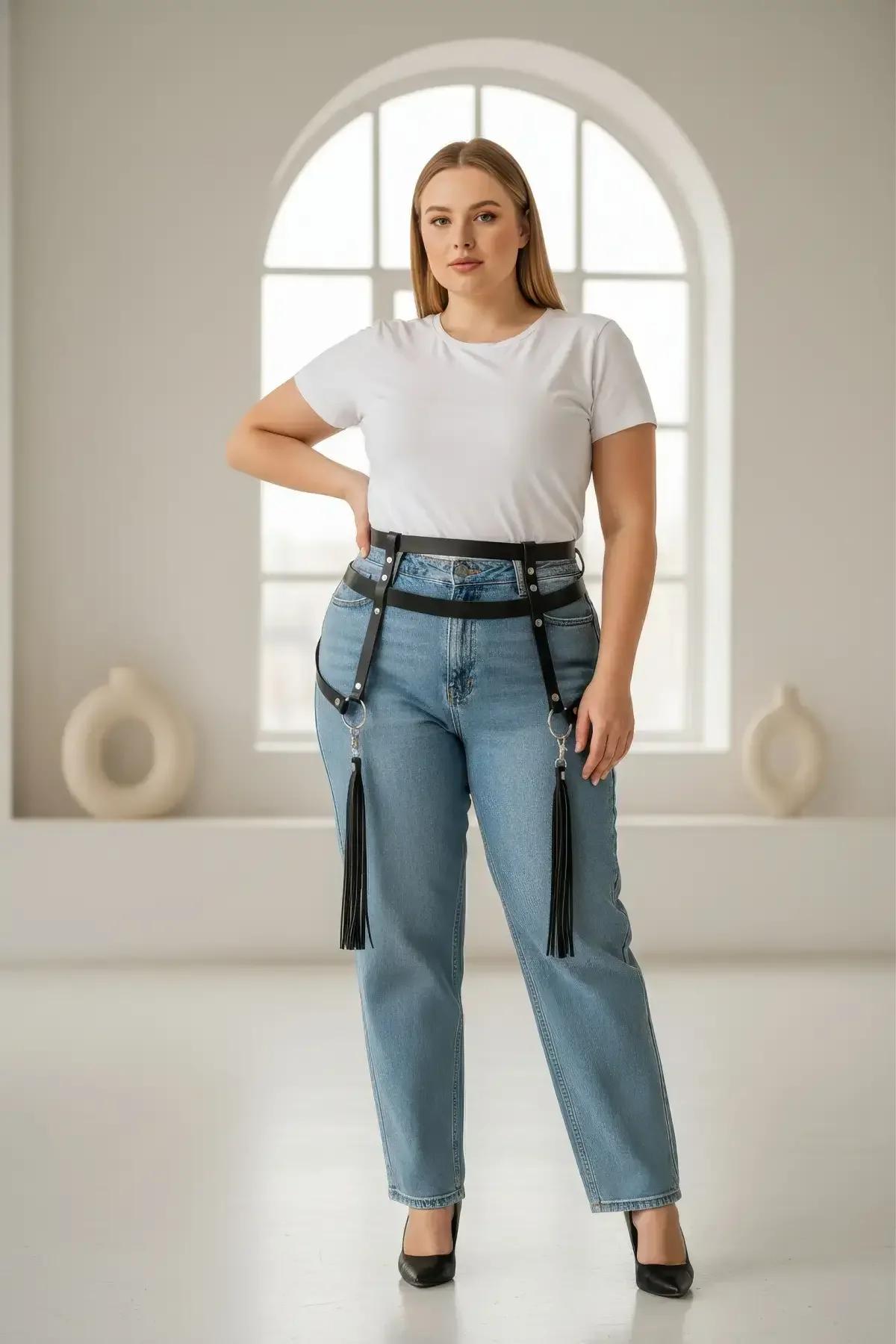 black faux leather waist harness with detachable tassel garters and silver O-ring hardware worn over jeans