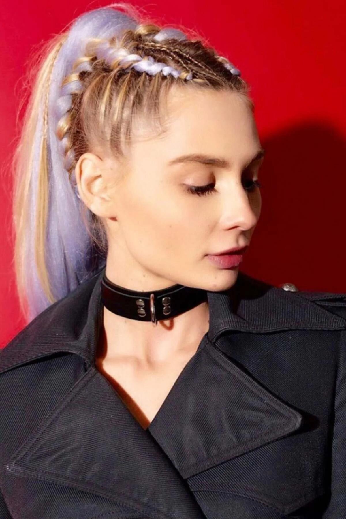 adjustable black faux leather wide-band choker collar with silver rivets and center ring worn on neck