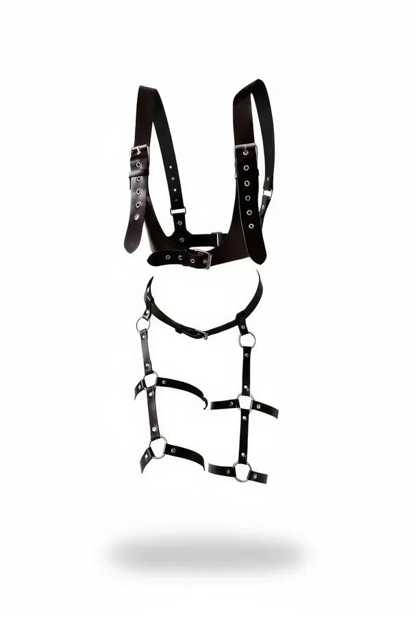 black faux leather full body harness with silver O-rings chest panel and adjustable leg strap cage flat lay