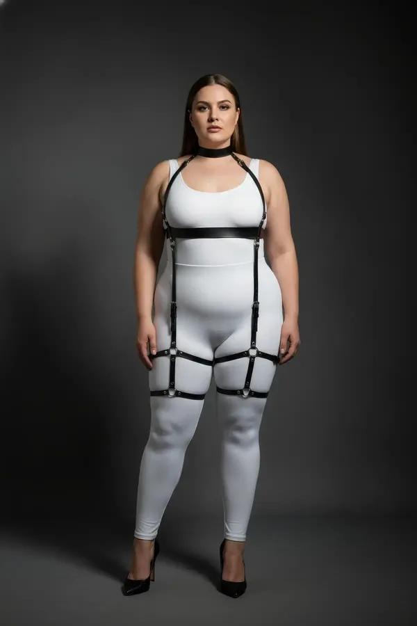 Black faux leather full body harness with halter neck collar, underbust band, vertical torso straps and cage-style thigh gart