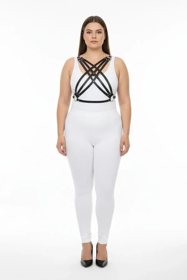 black faux leather chest harness with four crisscross diagonal straps and silver-tone studs worn over white outfit