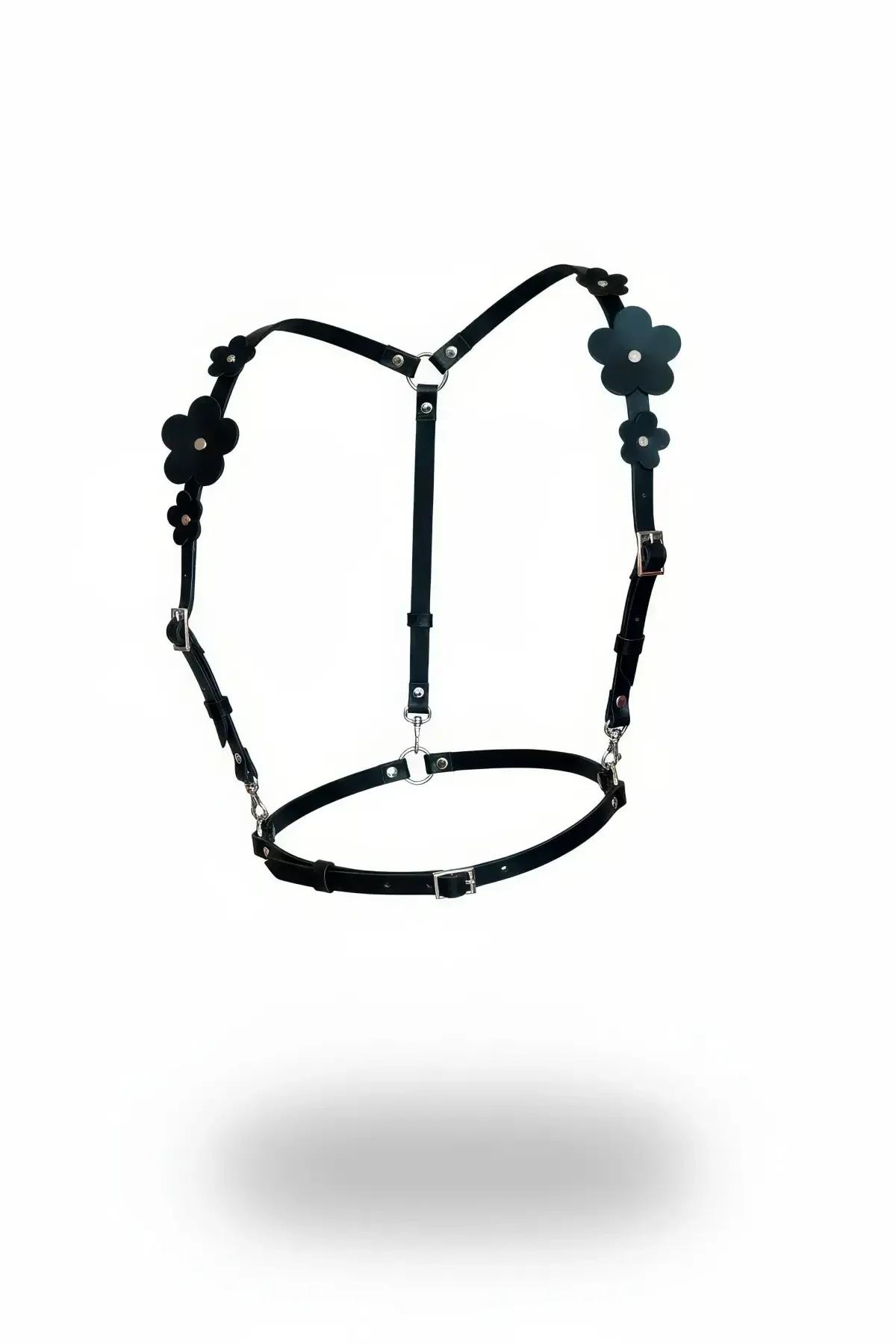 Black faux leather chest harness with daisy floral appliques, silver buckles and adjustable under-bust band, front view