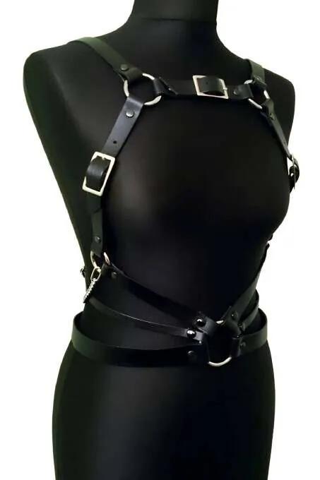 black faux leather full body harness with silver O-rings and adjustable buckle straps on mannequin front view