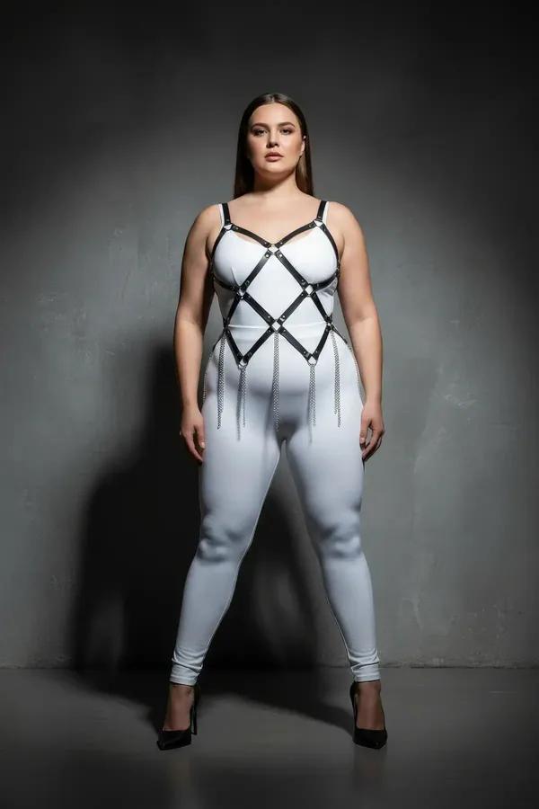 black faux leather full body harness diamond lattice with silver chain dangle worn over white catsuit