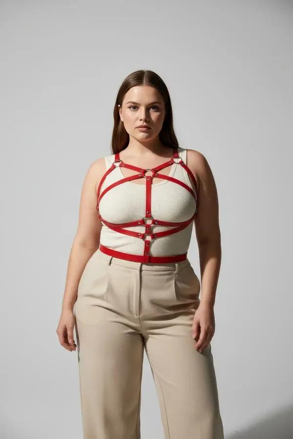 red faux leather multi-strap body harness crisscross front with gold O-rings worn over ribbed tank