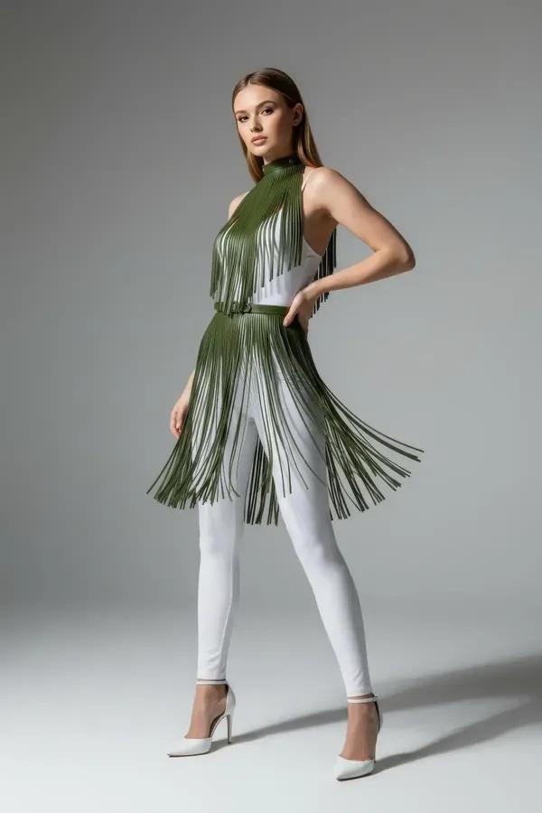 Olive green faux leather fringe harness set with halter neck and waist belt worn over white trousers