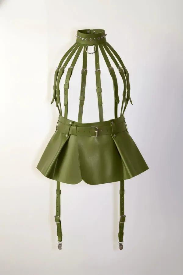 olive vegan leather caged underbust harness with pleated mini skirt and four silver garter clips, front view