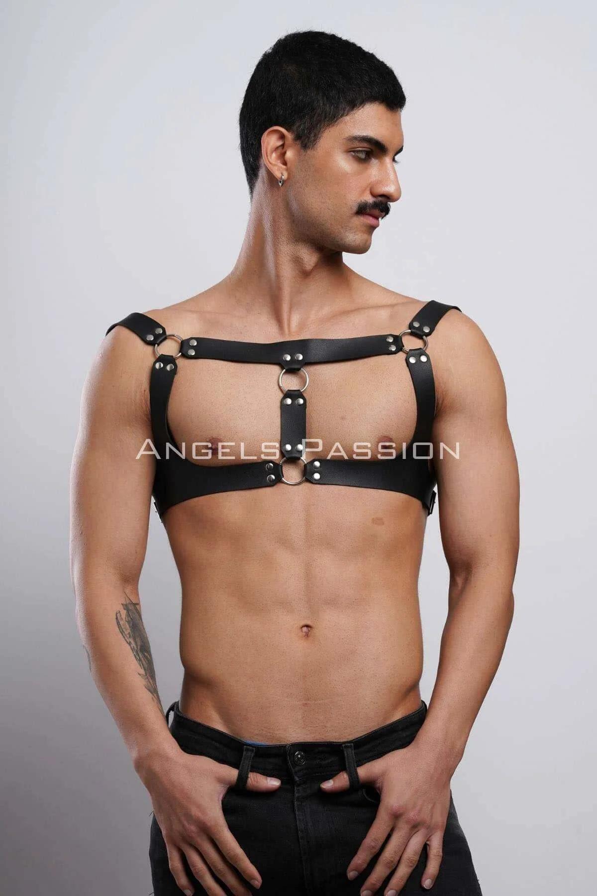 Black faux leather chest harness with dual stacked silver O-rings on riveted center bridge panel, wide shoulder strap