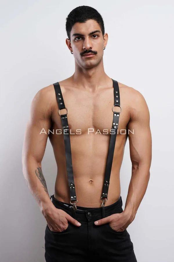 Black faux leather shoulder harness with gold O-rings and silver rivets, suspender-style vertical straps clipped to waistband