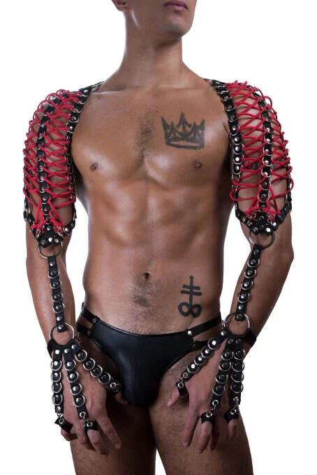 Red faux leather shoulder harness black chain lattice panels silver O-rings wrist cuffs worn by male model