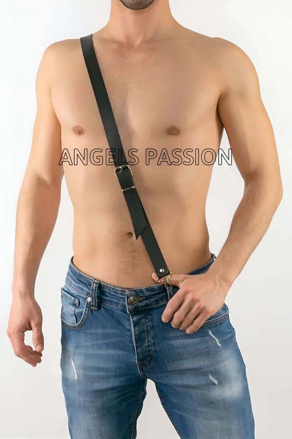 Black vegan leather single diagonal strap mens chest harness with gold-tone buckle and trouser clip, worn over bare chest wit