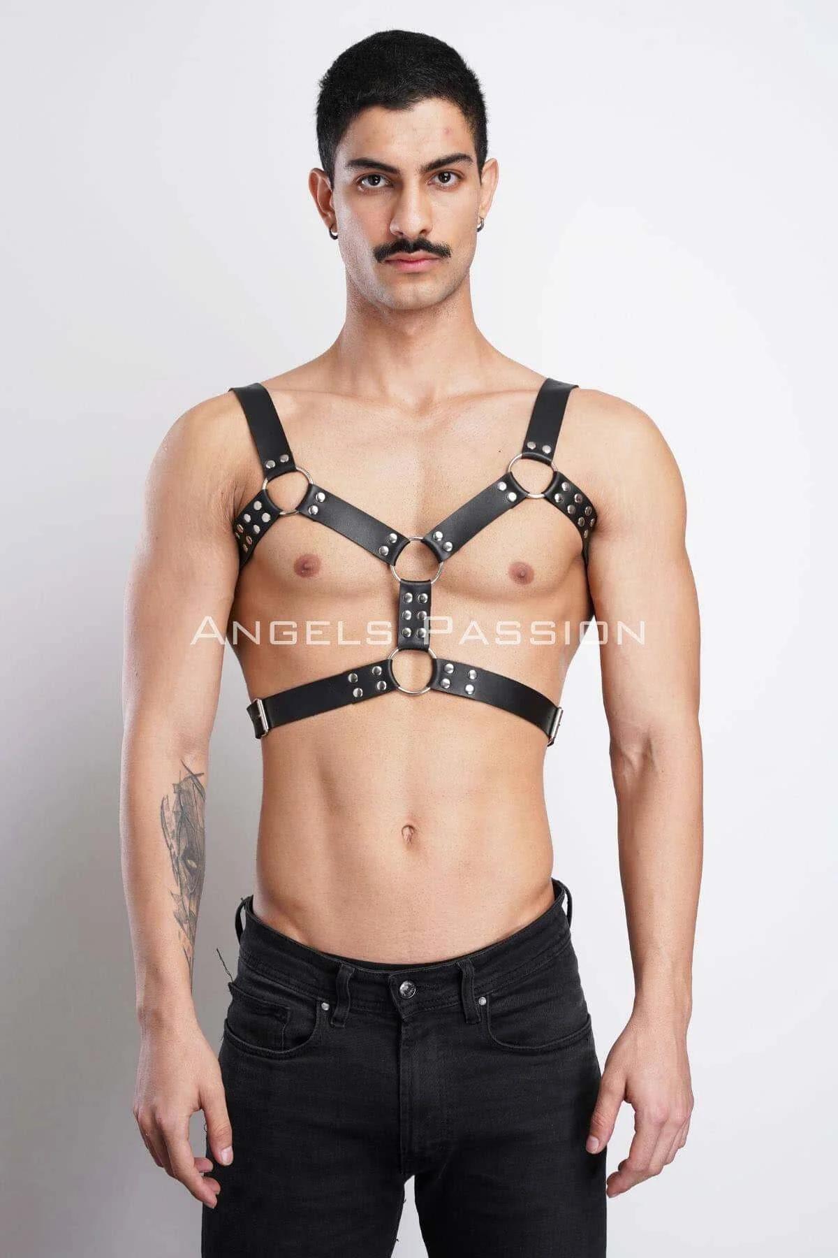 black faux leather chest harness with silver dome rivets and three O-rings worn front view