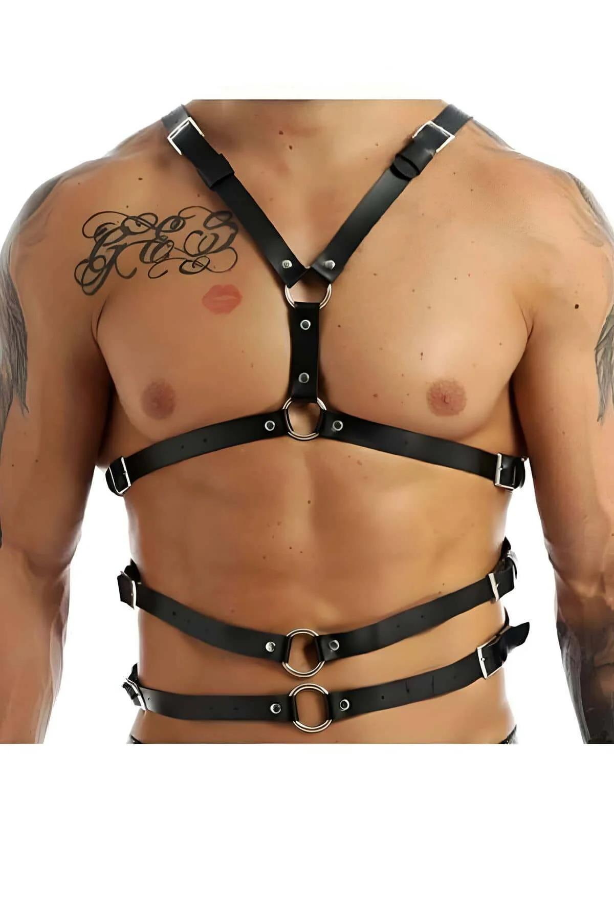Black faux leather chest harness with Y-strap, three silver O-rings and six buckles worn on male torso