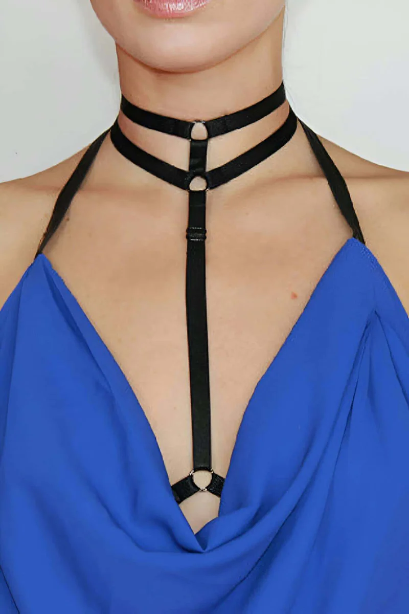 Close-up of black vegan leather choker straps with O-ring and adjustable buckle