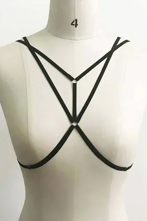 Black strappy body harness with central O-ring detail