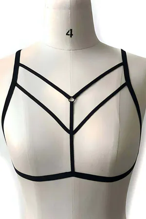 Black minimalist strappy O-ring body harness worn over a black top