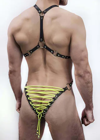 Black faux leather full body harness with neon yellow lacing and silver O-rings