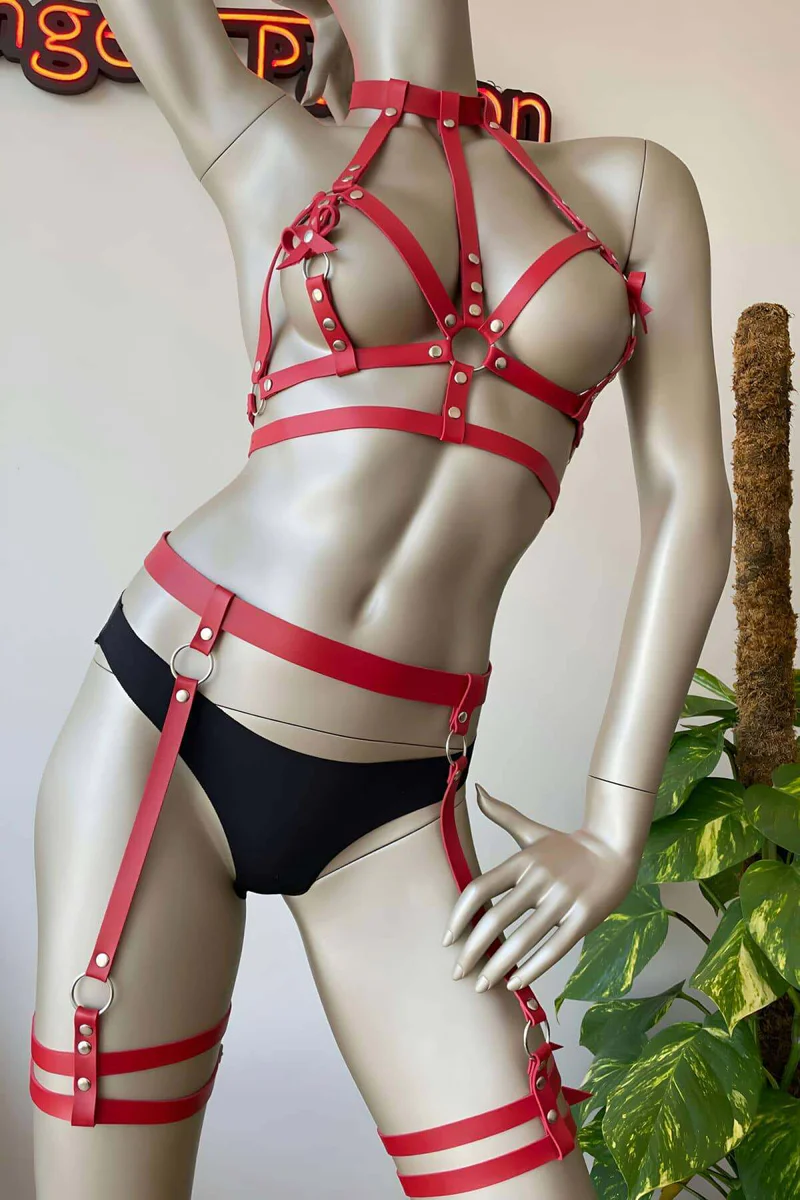 Close-up of gold-tone buckle on red faux leather thigh garter strap