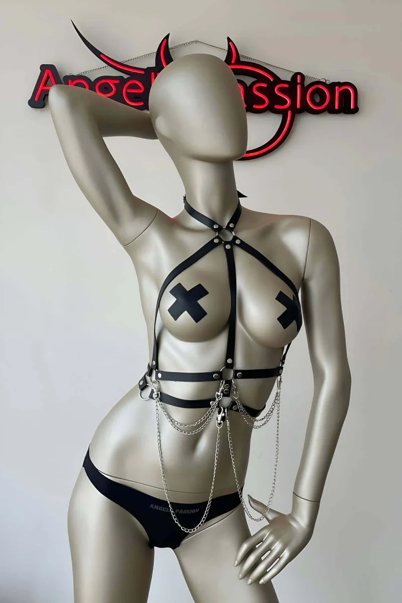 Black strappy body harness with O-ring and chain detail on mannequin