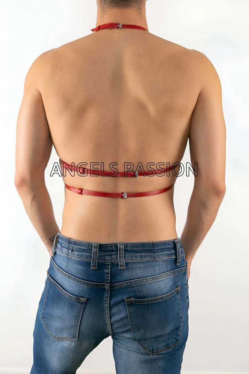 Close-up of red faux leather harness straps and buckle detail on man's back
