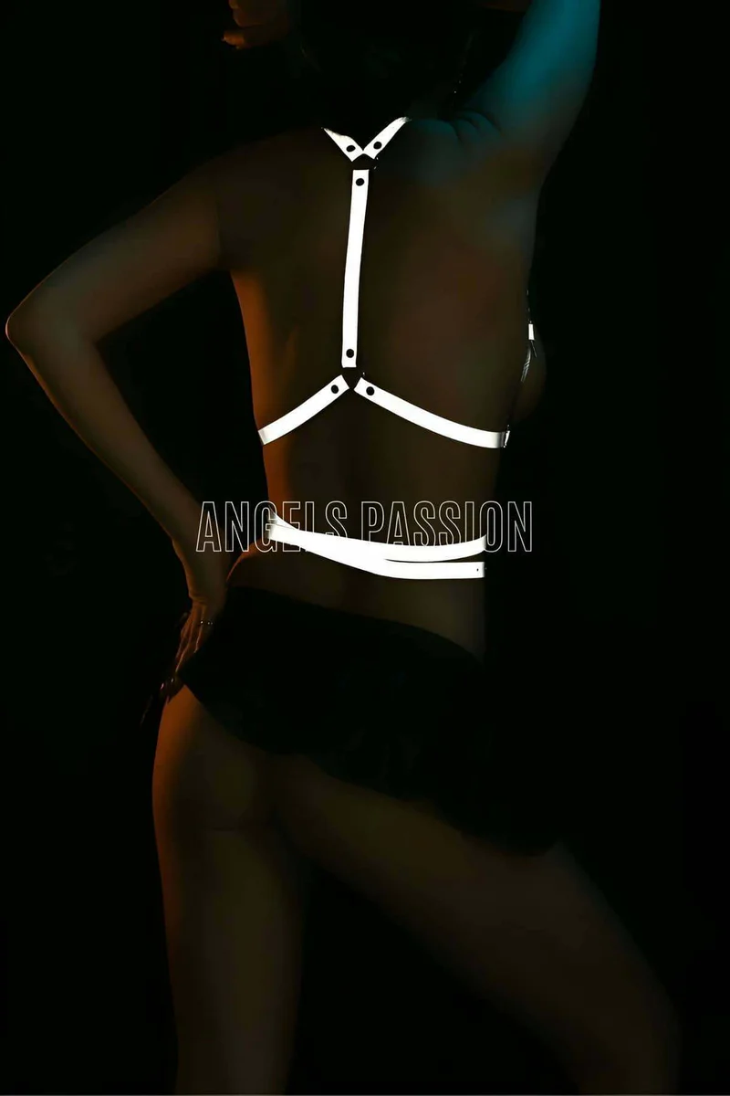 Model wearing reflective harness with black shorts, side view