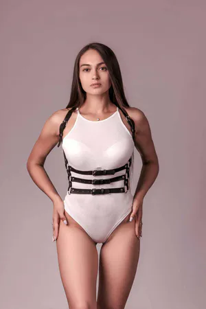 Black faux leather 3-strap body harness worn by a woman