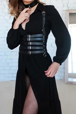 Black faux leather multi-strap corset body harness with matching choker worn over a black dress