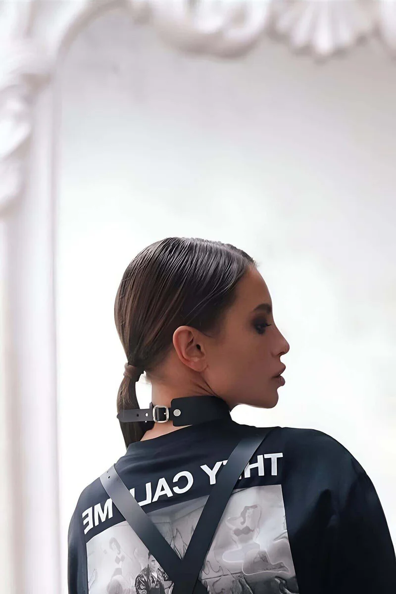 Close-up of black faux leather choker buckle detail