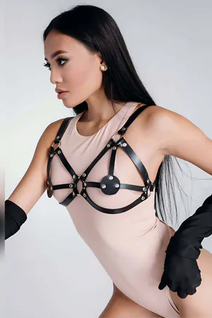 Black faux leather harness bra with adjustable straps and rhinestone detail