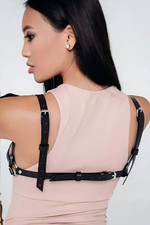 Black faux leather harness bra with adjustable straps and rhinestone detail