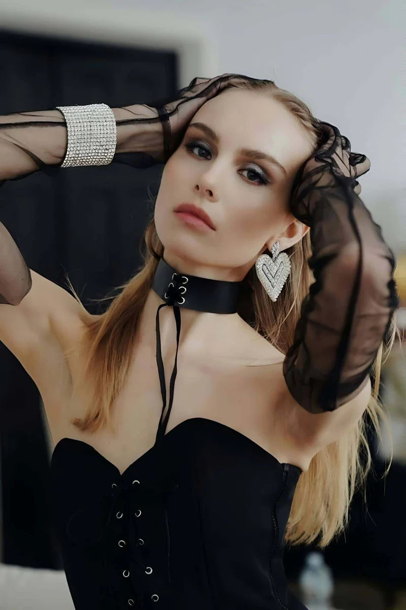 Model wearing black adjustable choker necklace with lace-up detail