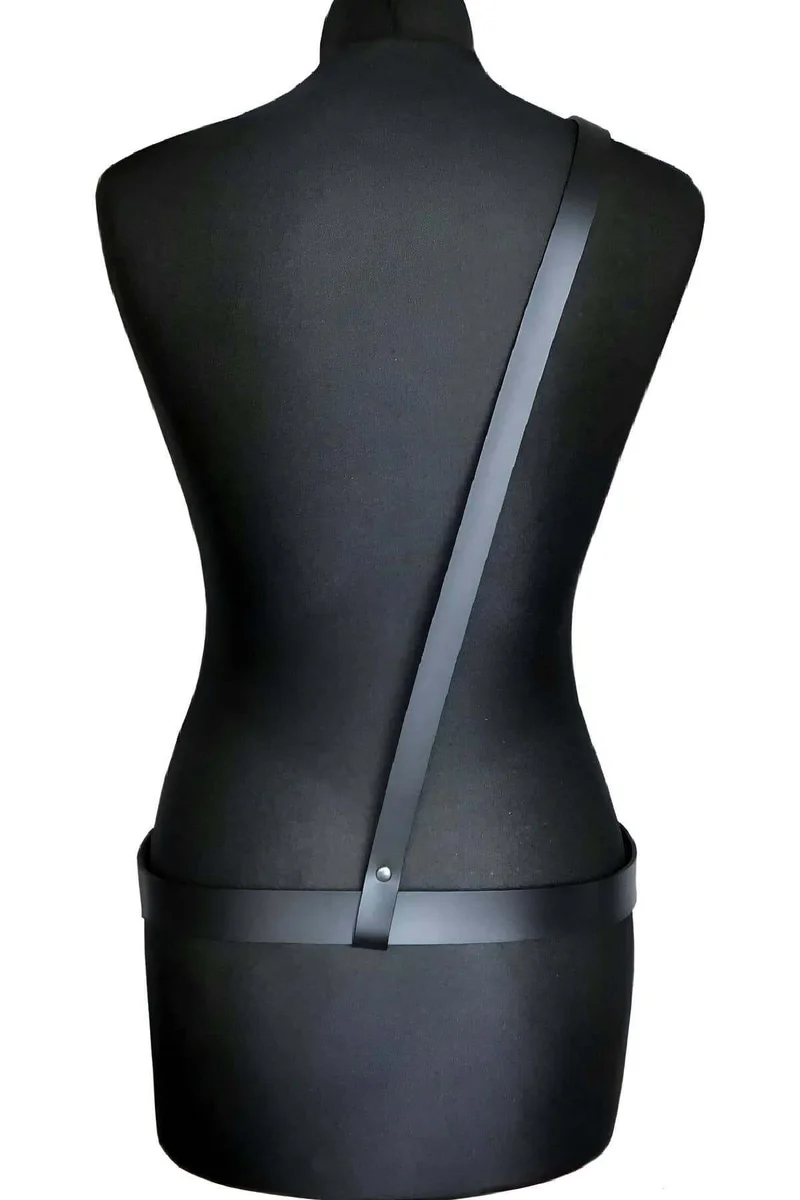 Detail of the adjustable shoulder strap on the black faux leather body harness.