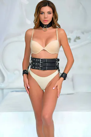 Black triple strap faux leather harness belt set with cuffs and choker worn by a model.