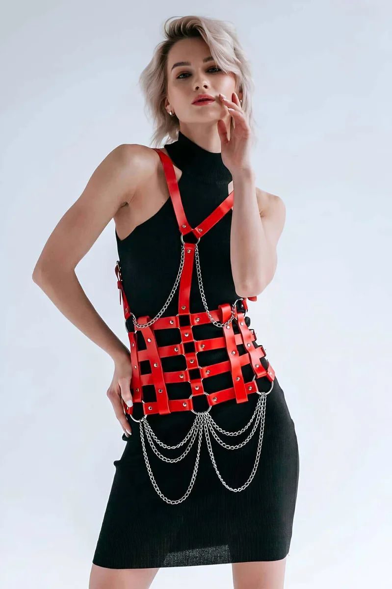 Side profile of red faux leather body harness showing strap configuration