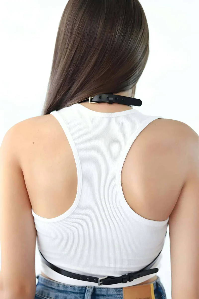 Side profile of black faux leather body harness with adjustable straps