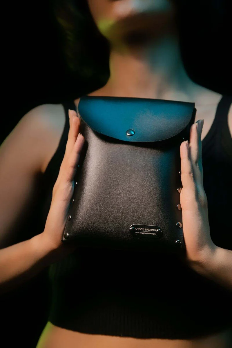 Black Vegan Leather Studded Chest Pouch on a person, front view with flap closure