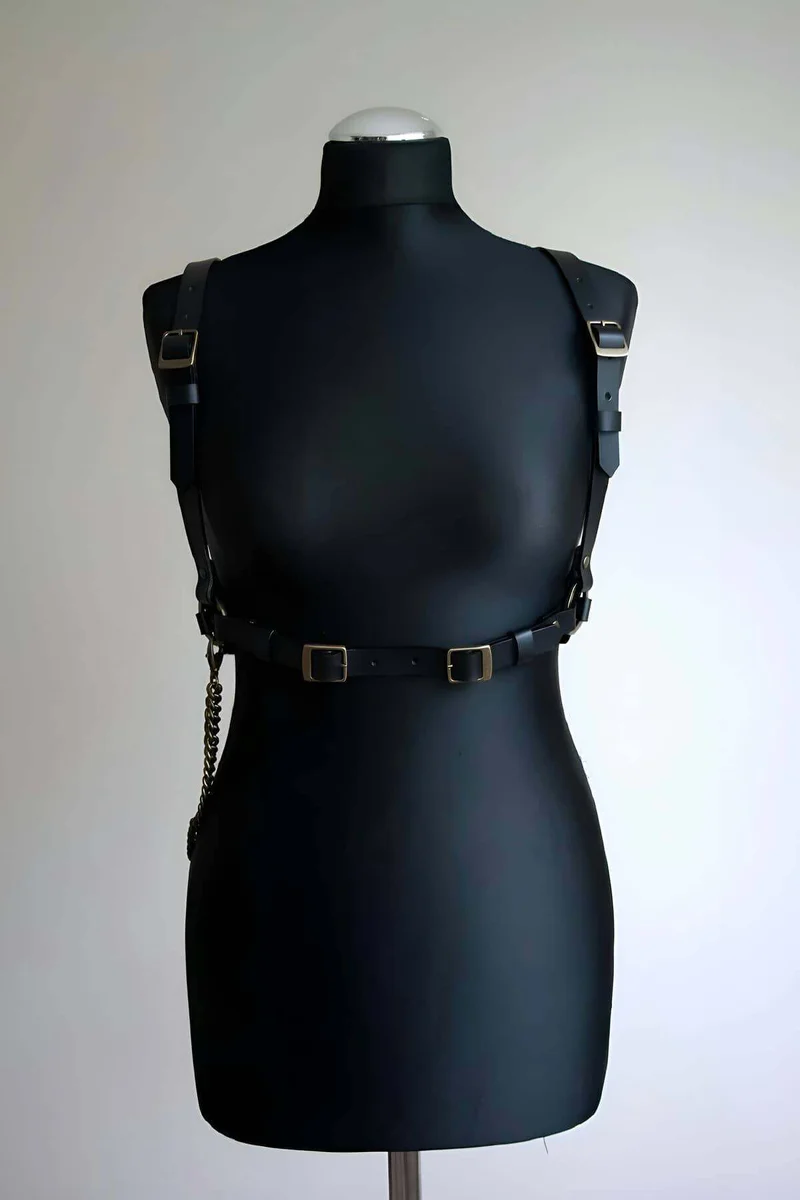 Black faux leather body harness with chain and gold buckles