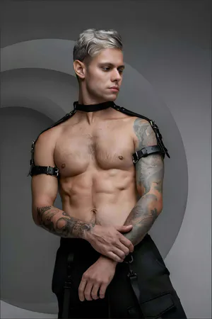 Black faux leather choker and shoulder harness set on male model
